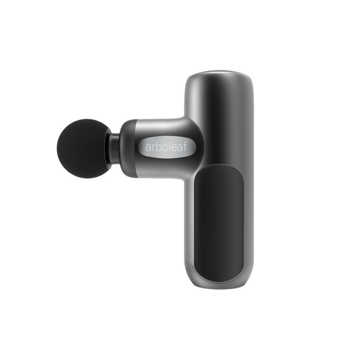 A handheld electric massager with a black color scheme, featuring a rounded head and a grip handle with a button on the side.