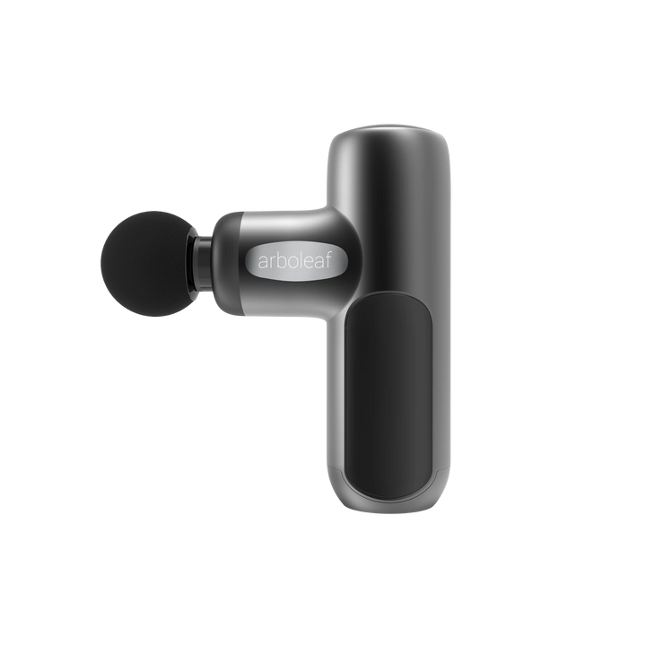 A handheld electric massager with a black color scheme, featuring a rounded head and a grip handle with a button on the side.